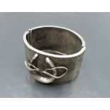 A Victorian white metal hinged cuff bangle stamped Sterling of equine interest with applique horse