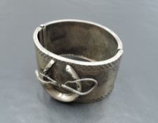 A Victorian white metal hinged cuff bangle stamped Sterling of equine interest with applique horse