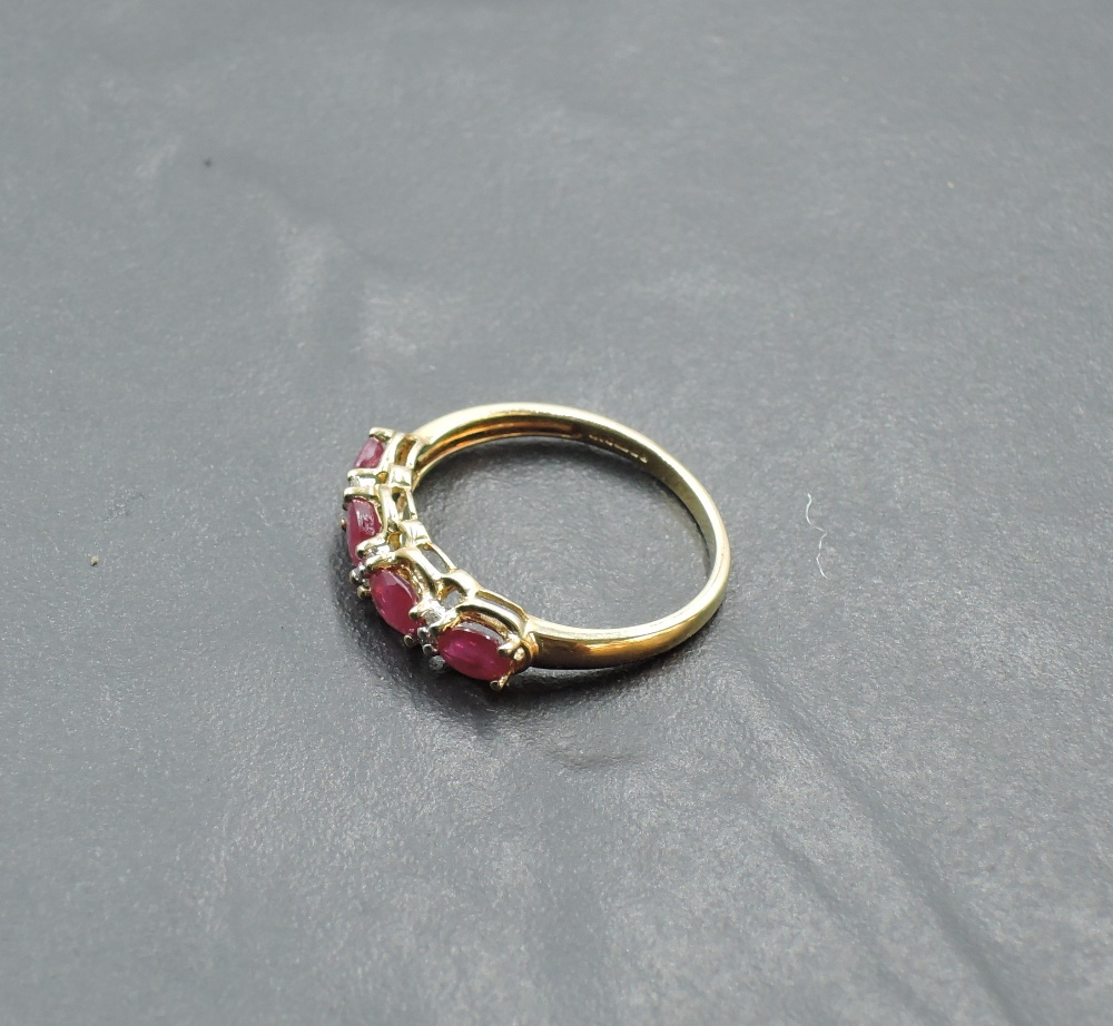 A 9ct gold dress ring having four oval ruby style stones with diamond chip spacers on a 9ct gold - Image 2 of 3