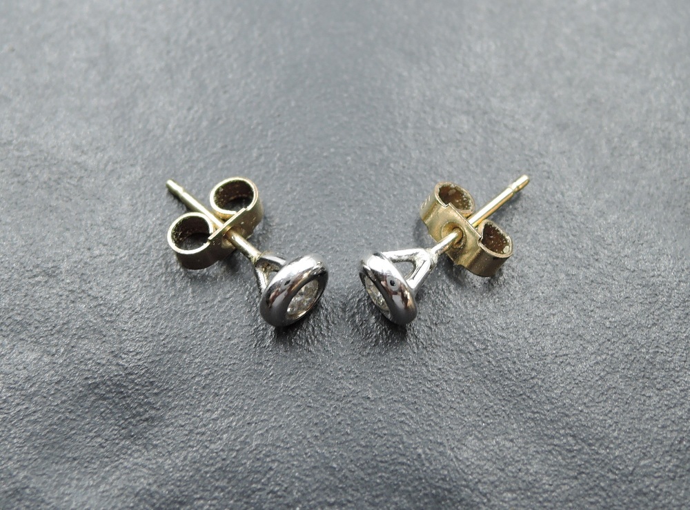 A pair of diamond solitaire stud earrings, total weight approx 0.125ct in 9ct white gold collared - Image 2 of 2