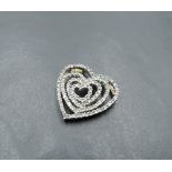 A 9ct white and yellow gold pendant of open heart shaped form having diamond chip decoration, approx