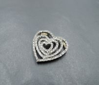 A 9ct white and yellow gold pendant of open heart shaped form having diamond chip decoration, approx