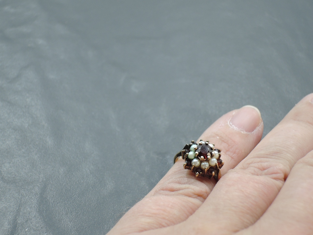 A garnet and seed pearl triple cluster ring having a claw set mount on a yellow metal loop, tests as - Image 3 of 3