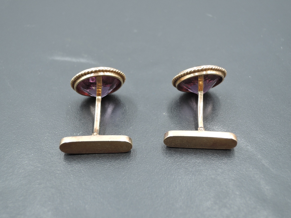 A pair of yellow metal cufflinks stamped 14A having facet cut heat treated amethyst stones and bar - Image 2 of 2