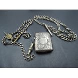 An HM silver vesta case and watch chain, with similar white metal watch chain