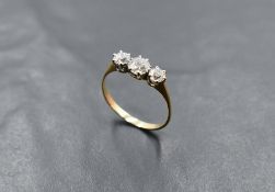 A diamond trilogy ring, total approx 1.25ct in a claw set mount on a yellow metal loop, no marks,