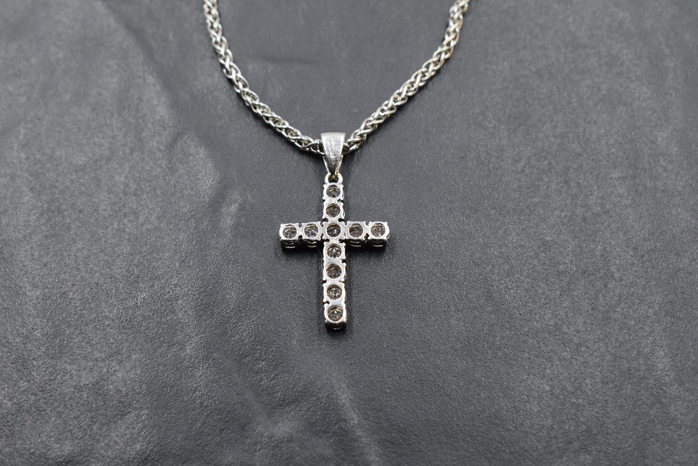 An eleven stone diamond cross pendant, total approx 0.75ct, in an 18ct white gold mount on a 9ct - Image 2 of 3