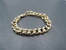 A 9ct gold curb link bracelet of heavy form having dog leash clasp, approx 56.5g
