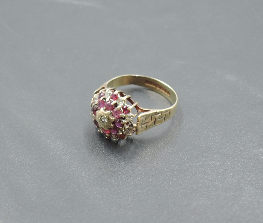 A ruby and diamond chip triple cluster ring in a claw set basket mount with engraved shoulders on - Image 2 of 3