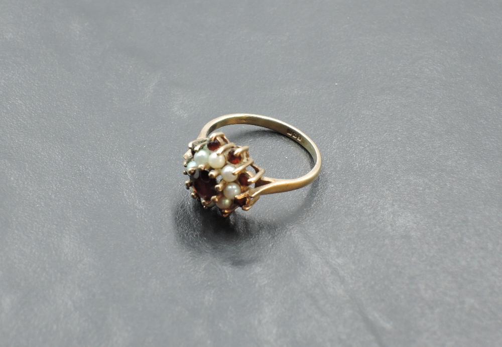 A garnet and seed pearl triple cluster ring having a claw set mount on a yellow metal loop, tests as - Image 2 of 3