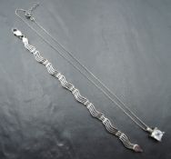 A silver articulated four bar wave style bracelet, approx 7.5' & 15.1g and a facetted crystal