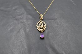 A 9ct gold Art nouveau style pendant with diamond chip and amethyst detail on a 9ct gold chain,