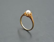 A cultured pearl solitaire ring in a frilled mount on a yellow metal loop stamped 585, size M &