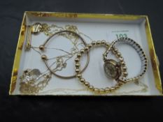 A selection of 9ct gold jewellery including torque bangle, heart pendant, chains and a lady's
