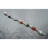 A seven panel mixed agate bracelet in white metal collared mounts stamped silver with chain