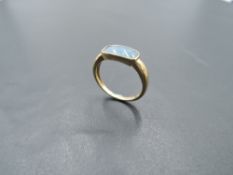 A 9ct gold ring having a faux black opal panel in collared mount, size L & approx 2g