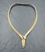 An 18ct gold collarette necklace of knotted plaited form with concealed clasp, approx 61.5g