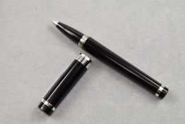A Pasha De Cartier Rollerball having black barrel with silver cuff to lower potion and silver