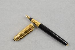 A Pashier de Cartier fountain pen having black barrel with ribbed gold cap, Number impressed to