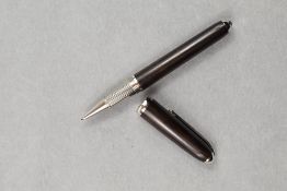 A Louis Cartier Rollerball, having ebonised wood effect barrel and cap and silver cuff to cap,
