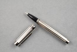 A Cartier Rollerball, having silver barrel and cap with textured hatch effect etched detail,