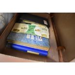 A suitcase containing an assortment of Brooke bond albums, various interests to include flowers,