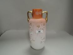 An early 20th century art glass vase having double colour skin with twin handles and floral