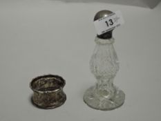 A silver topped cut-glass scent bottle, of baluster form with flared base 12cm sold along with a