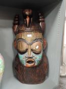 A large sized modern African tribal carved wood mask having copper and glass bead decoration