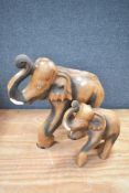A large ethnic wood hand carved elephant and calf