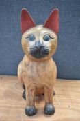 A large hard wood carved figure of a cat approx 65cm tall