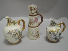 Three pieces of fine Royal Worcester blush ivory including two gilt handle jugs hand painted with