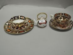 Two modern Royal Crown Derby tea cup and saucer sets no.2451 and no.1206 with a miniature RCD