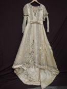 A cream silk wedding dress around 1915-1920, having abundant rhinestone and beaded detailing