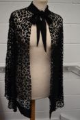 A 1930s black lace cover up, having wide sleeve openings and crepe georgette scalloping to hem and