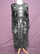 A 1920s black Devoré dress having long sleeves and drop waist, press stud fastening to faux