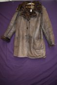 A vintage brown Antartex lamb skin jacket, having curly lining.