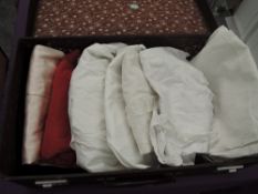 A vintage suitcase containing assorted vintage underwear and Victorian petticoats, shifts and