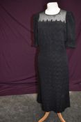 A late 1930s black dress having textured zig-zag pattern with robust tulle like yolk and cuff
