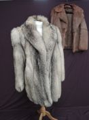A dyed fox fur coat and a shorter Coney jacket.
