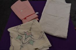 A pair of vintage pink bed sheets, a cut-work table cloth and an extensively embroidered Edwardian