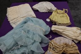 A miscellany of items consisting of vintage and antique bonnets, 1960s nylon baby doll, white cotton