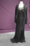 A 1930s bias cut black lace evening gown, bodice lined in lilac crepe and the skirt in black silk,