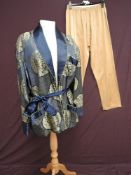 A mid century oriental smokers jacket of blue silk/satin having gold thread embroidered motifs, a