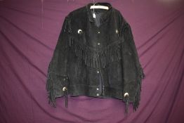 A vintage black suede jacket having tassel detailing, larger size.