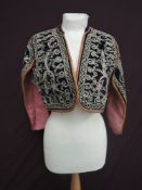 A short ethnic styled jacket, appears to be around 1930s, having braiding and sequin detailing on