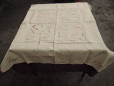 An unusual linen table cloth having a number of embroidered signatures, dates of marriages and names
