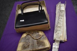 An unused black 1960s clasp top handbag in box, a crocodile or similar reptile bag and a evening