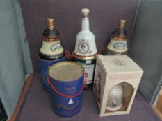 A collection of eight Bells Wade Decanters, Christmas 1989x2, Christmas 1990, Prince Andrew and