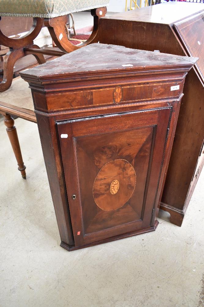 A 19th Century mahogany corner cupbpard having shell design inlay decoration